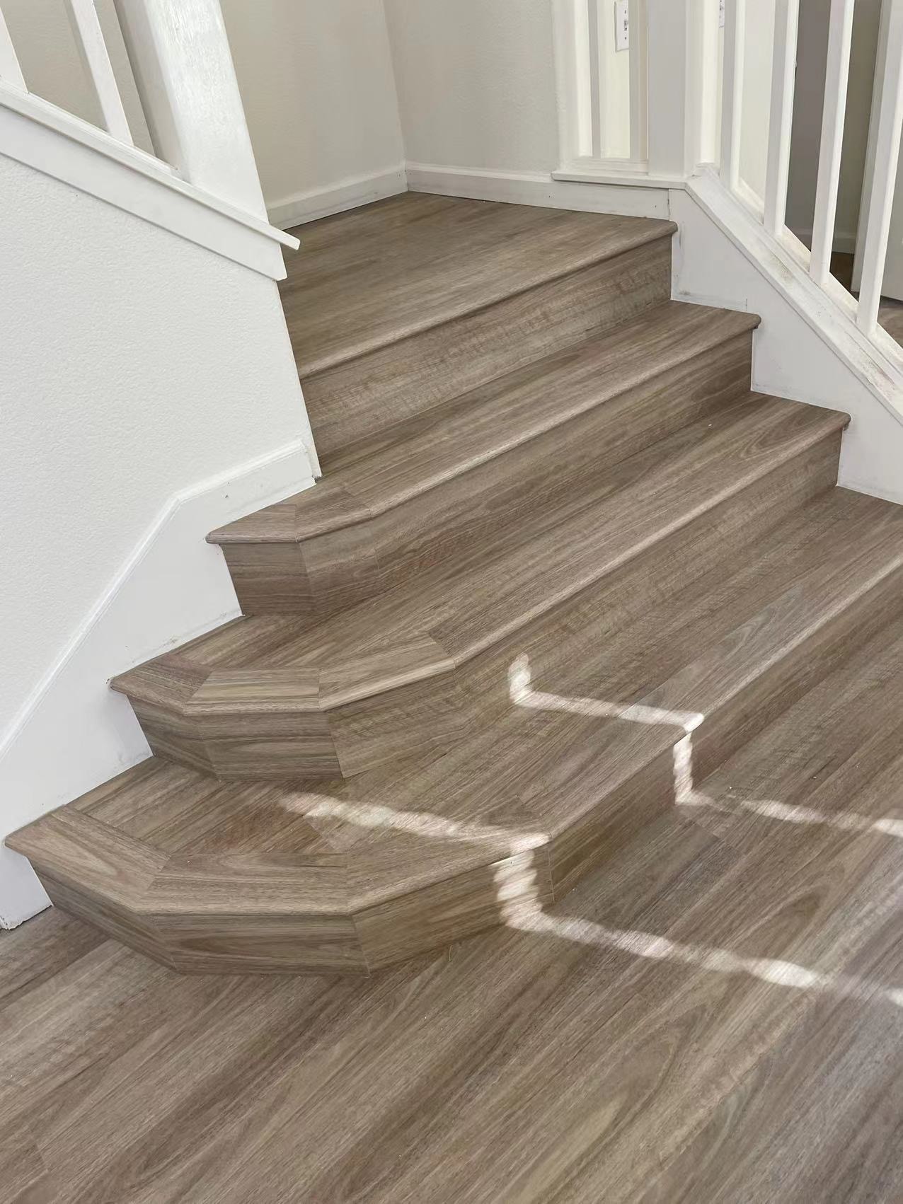 SPC luxury vinyl staircase with grey wood-look finish