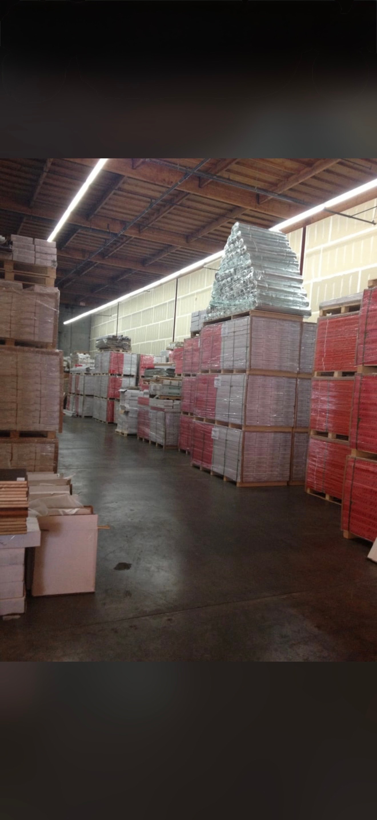 Warehouse stacked with flooring pallets